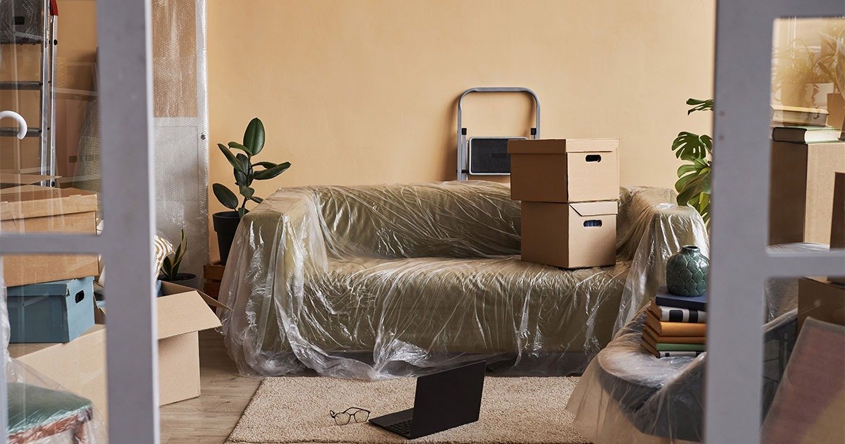A room filled with packed boxes and furniture, illustrating preparation for long-distance moving.