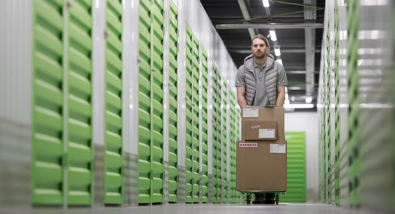 A cluttered storage room filled with stacked boxes and various pieces of furniture.
